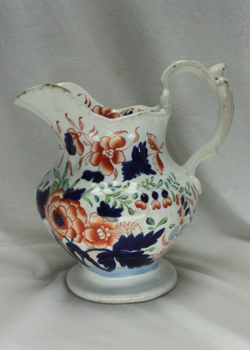 Hand coloured jug with ornate handle Hand coloured jug with ornate handle